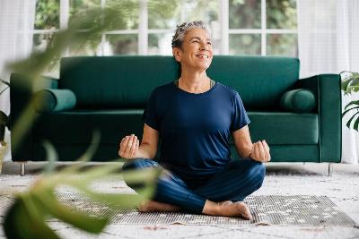 A woman meditating in her living room