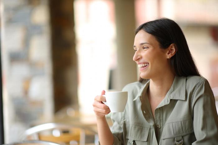 A woman drinking a cup of coffee